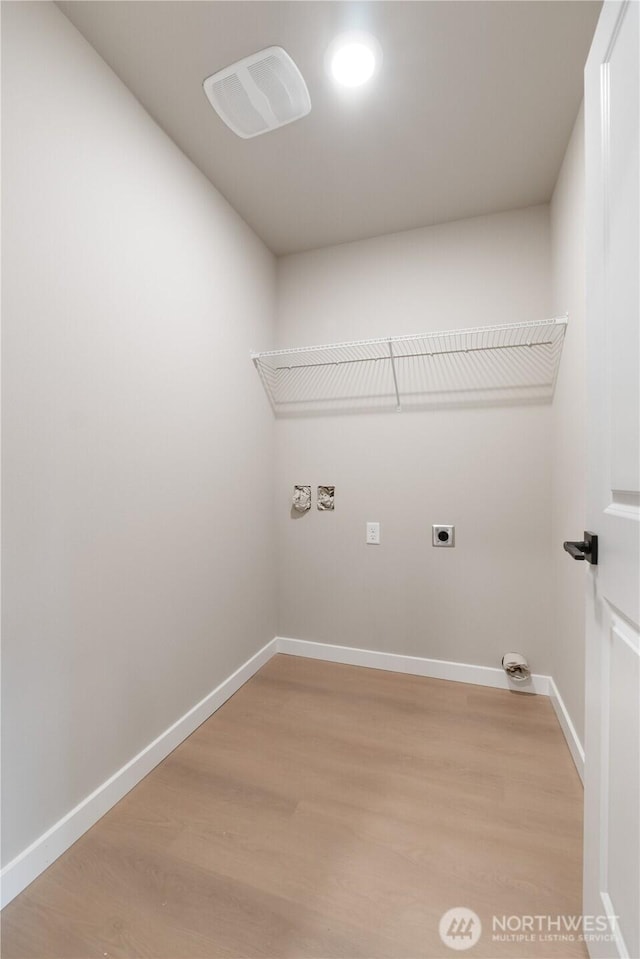 washroom featuring baseboards, laundry area, light wood-style flooring, and hookup for an electric dryer