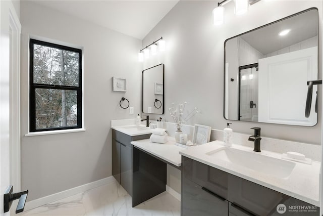 bathroom with lofted ceiling, vanity, baseboards, marble finish floor, and a shower stall