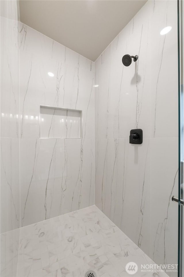 full bath featuring a marble finish shower