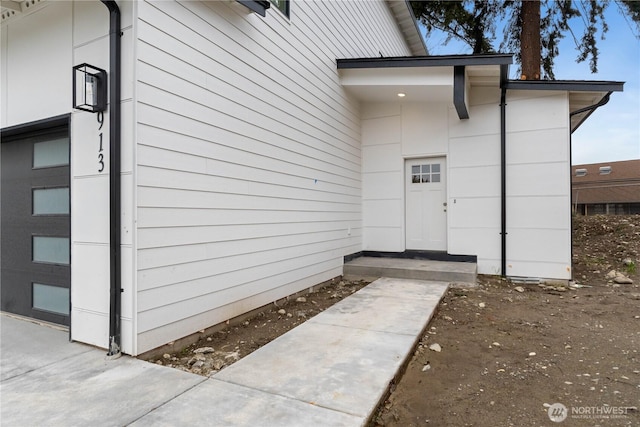 view of exterior entry with a garage