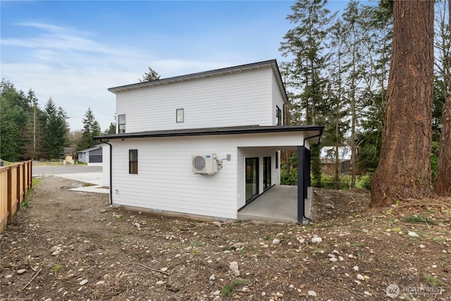 back of property with a patio area and ac unit