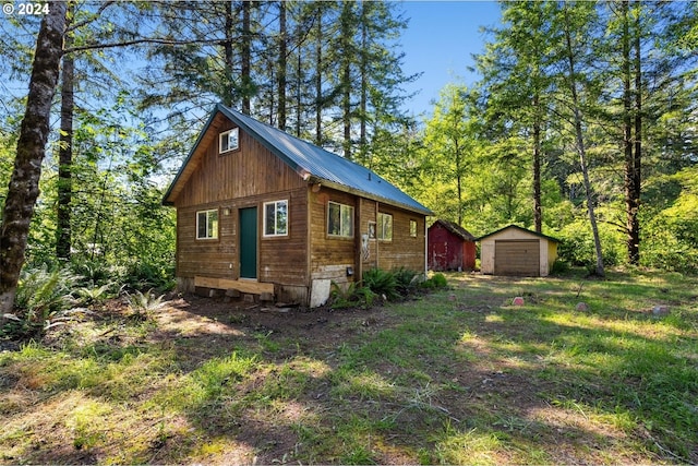 view of side of home featuring a garage and an outdoor structure