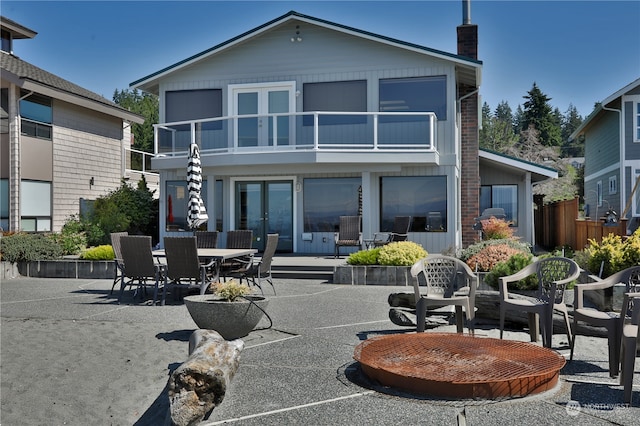 rear view of house featuring a balcony and a patio area