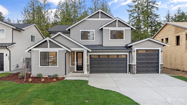 craftsman-style home featuring a front lawn and a garage