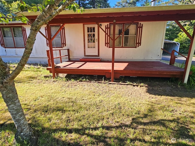 exterior space with a deck and a lawn