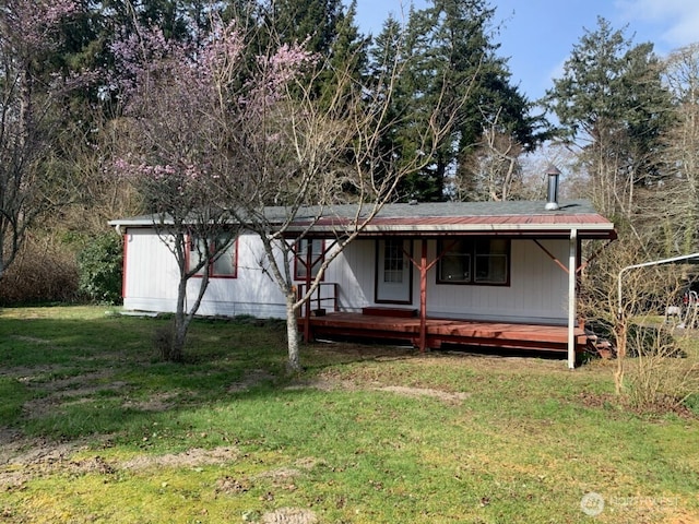 view of front of property with covered porch and a front yard