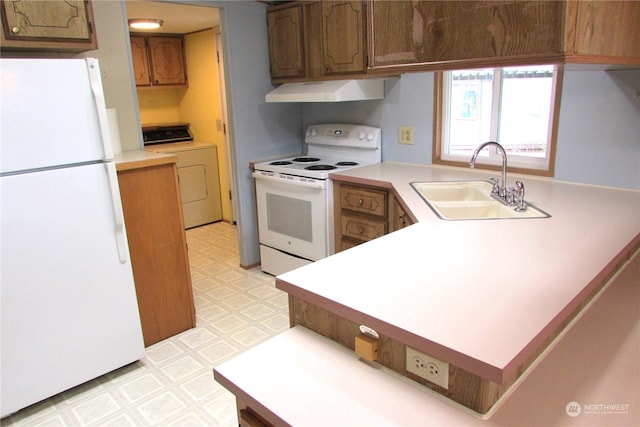 kitchen with white appliances, washer / clothes dryer, and sink