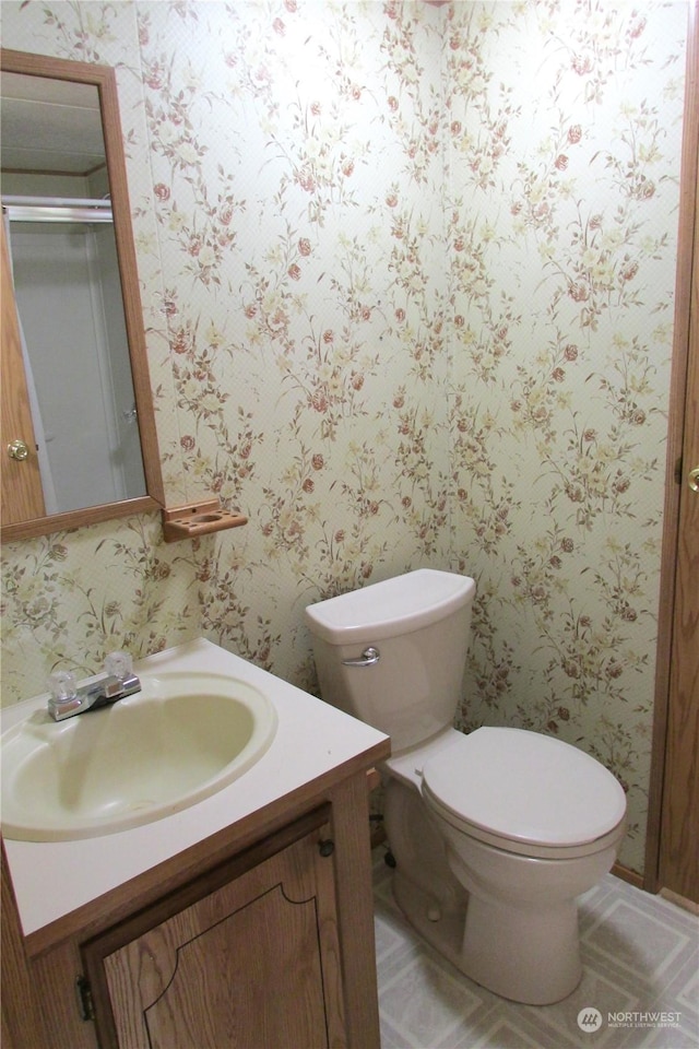 bathroom featuring vanity and toilet