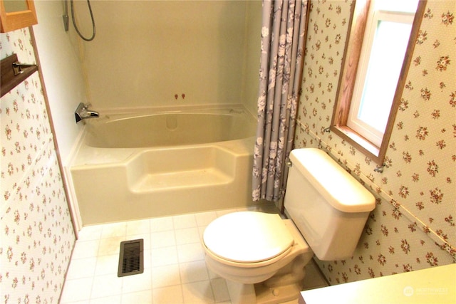 bathroom with tile patterned floors, shower / bath combo, and toilet