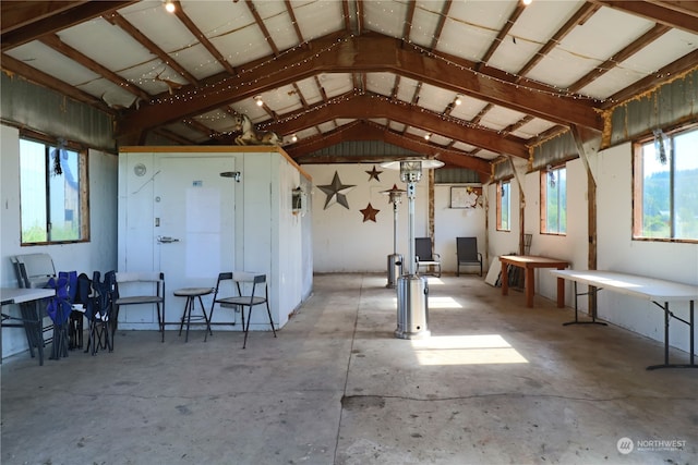 misc room with concrete floors and lofted ceiling