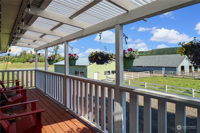 wooden terrace featuring a yard