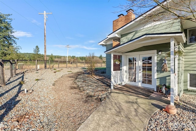 view of yard featuring french doors and a rural view