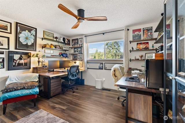 office area with a textured ceiling, dark hardwood / wood-style floors, and ceiling fan