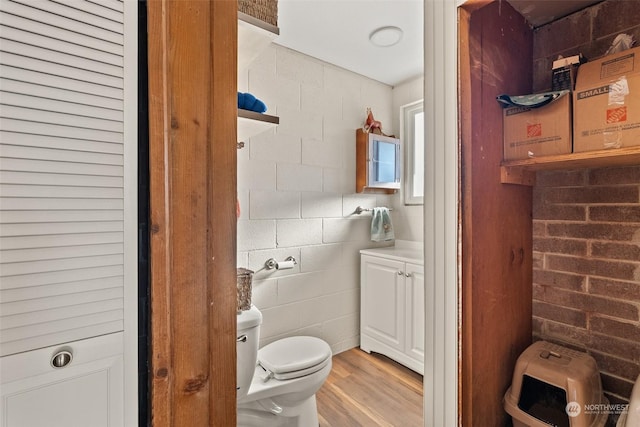 bathroom featuring toilet and wood-type flooring