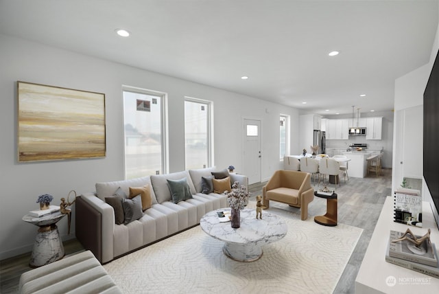 living room with wood finished floors and recessed lighting