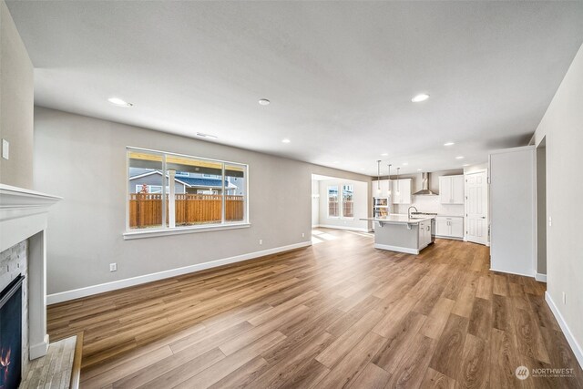 unfurnished living room with light wood-type flooring