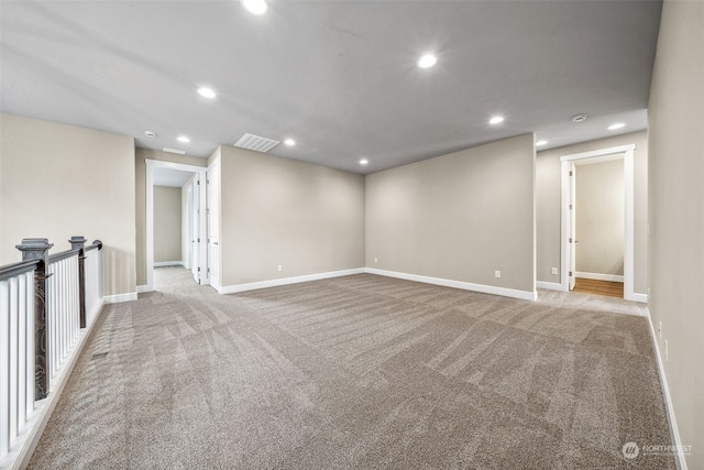 unfurnished room featuring light colored carpet