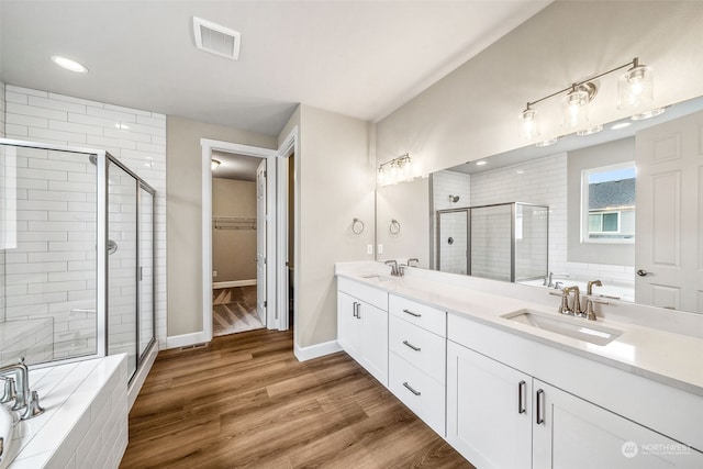 bathroom with vanity, shower with separate bathtub, and hardwood / wood-style flooring