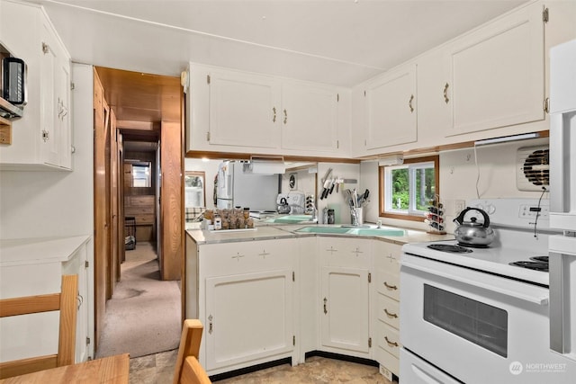 kitchen featuring white cabinetry and white appliances