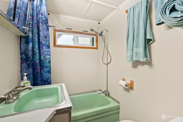 full bathroom with shower / bath combo with shower curtain, vanity, and toilet