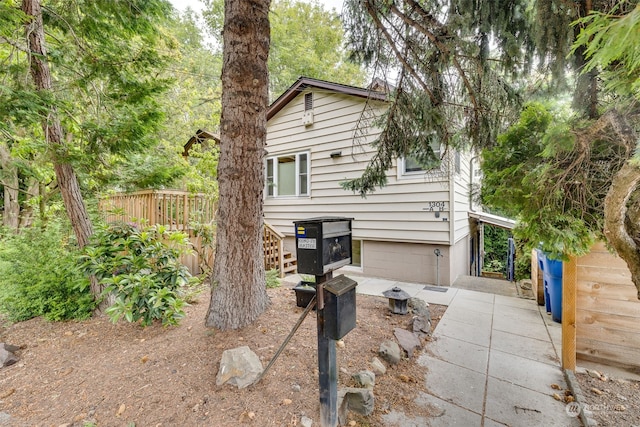 exterior space featuring a garage and a deck