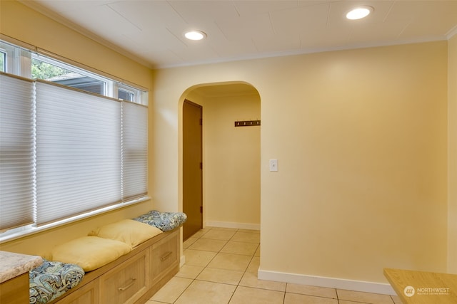 interior space featuring ornamental molding and light tile flooring