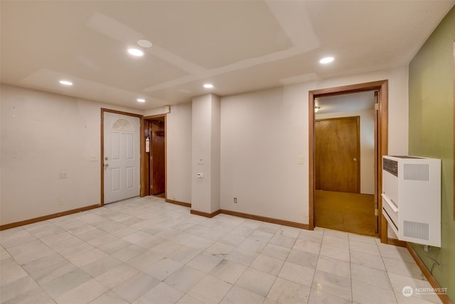 empty room with light tile flooring and radiator heating unit