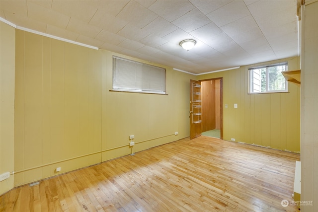 interior space featuring ornamental molding and light wood-type flooring