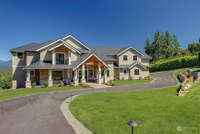 craftsman house with covered porch and a front lawn