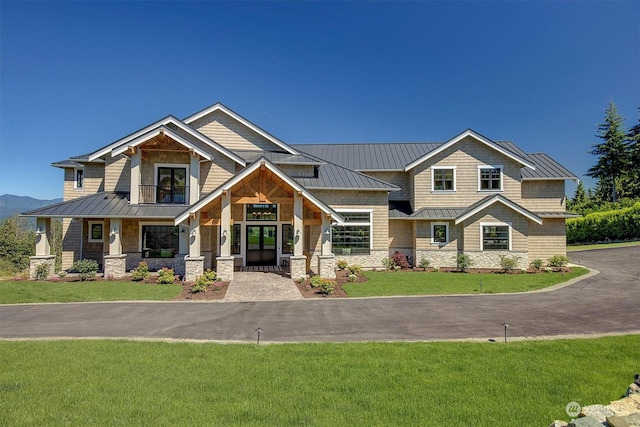 craftsman-style house featuring covered porch and a front lawn