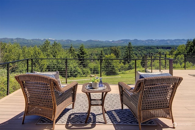 deck featuring a mountain view and an outdoor hangout area