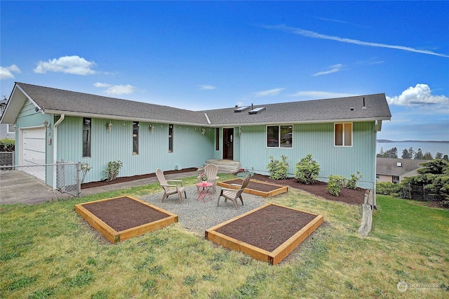 rear view of property with a lawn and a garage