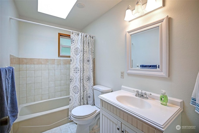 full bathroom featuring a skylight, shower / bath combo with shower curtain, vanity, and toilet