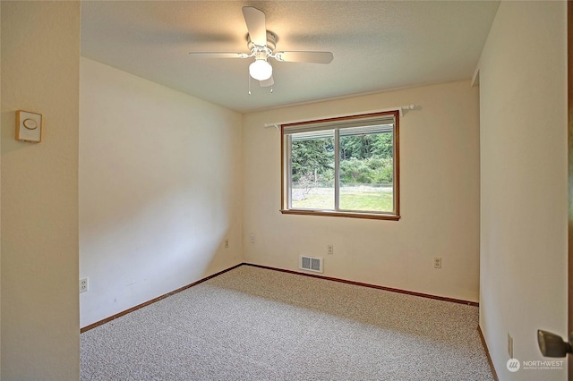 spare room featuring ceiling fan and carpet floors