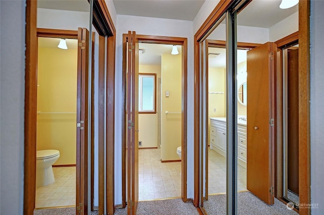 hallway featuring light carpet