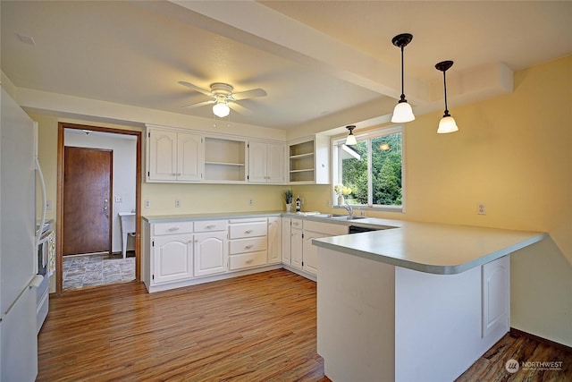 kitchen with kitchen peninsula, white cabinetry, ceiling fan, and hanging light fixtures