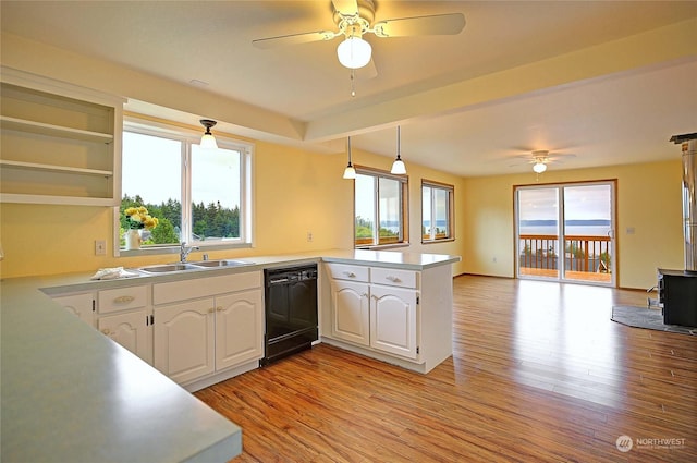 kitchen featuring dishwasher, white cabinets, sink, light wood-type flooring, and kitchen peninsula