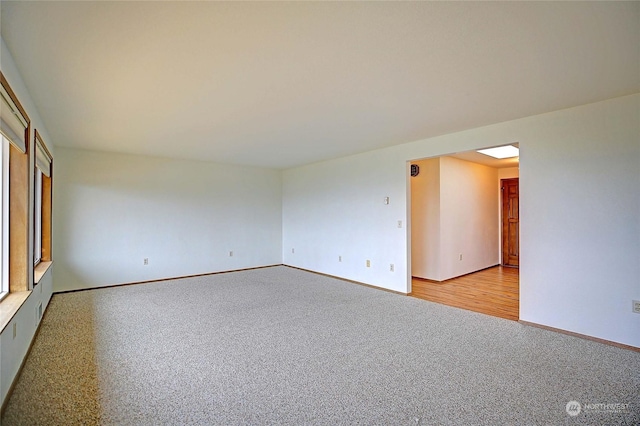 unfurnished room with light colored carpet