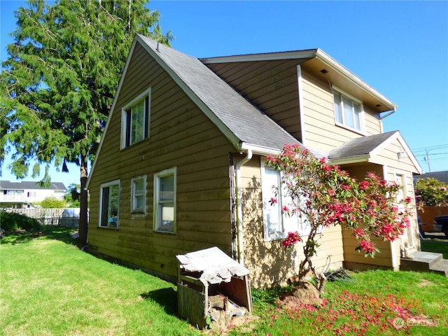 view of side of home featuring a lawn