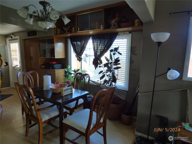 dining room featuring a healthy amount of sunlight and a notable chandelier