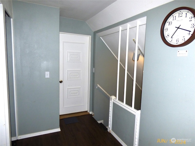 hall with lofted ceiling and dark hardwood / wood-style floors