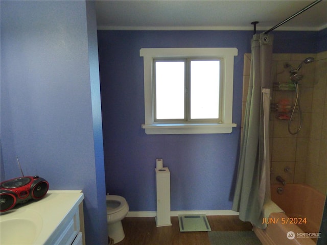 full bathroom with vanity, hardwood / wood-style floors, shower / bathtub combination with curtain, and toilet