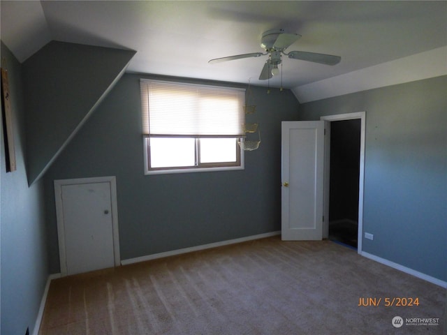 bonus room featuring lofted ceiling, carpet flooring, and ceiling fan