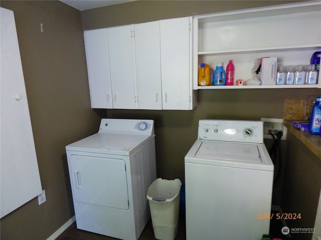 laundry area featuring cabinets and washer and clothes dryer