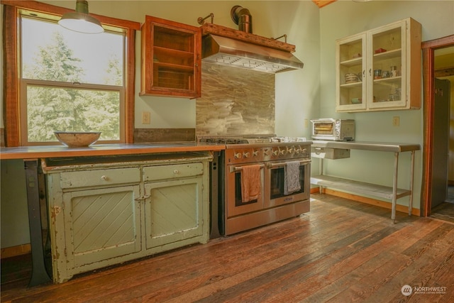 kitchen with pendant lighting, dark hardwood / wood-style flooring, double oven range, and extractor fan