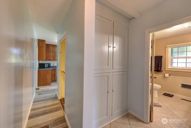 hallway featuring light tile patterned floors