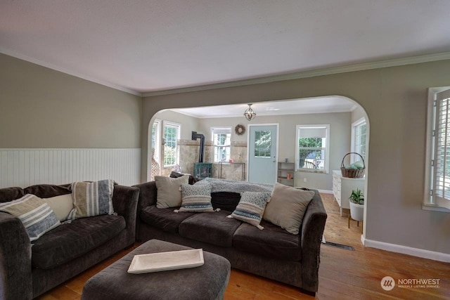 living room featuring light wood-type flooring and ornamental molding