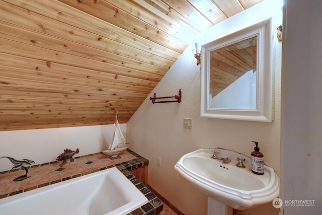 bathroom featuring wood ceiling, sink, and vaulted ceiling