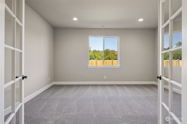 unfurnished room featuring carpet flooring and french doors