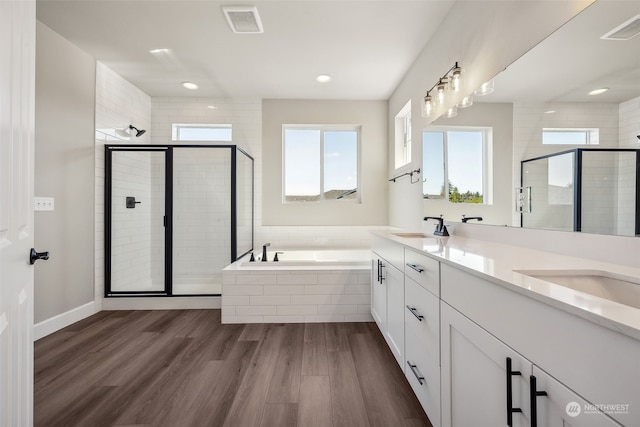 bathroom featuring vanity, hardwood / wood-style floors, and separate shower and tub